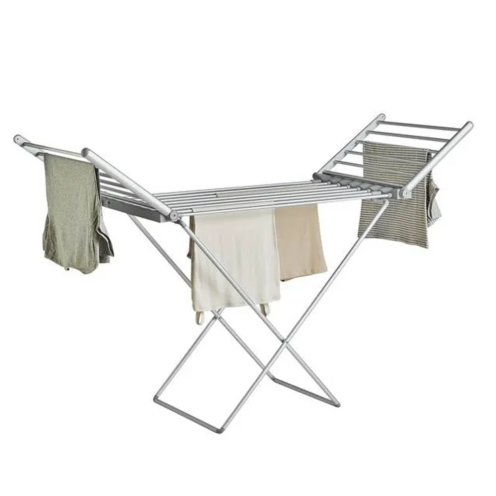 Silver electric heated clothes airer with extended wings drying laundry.